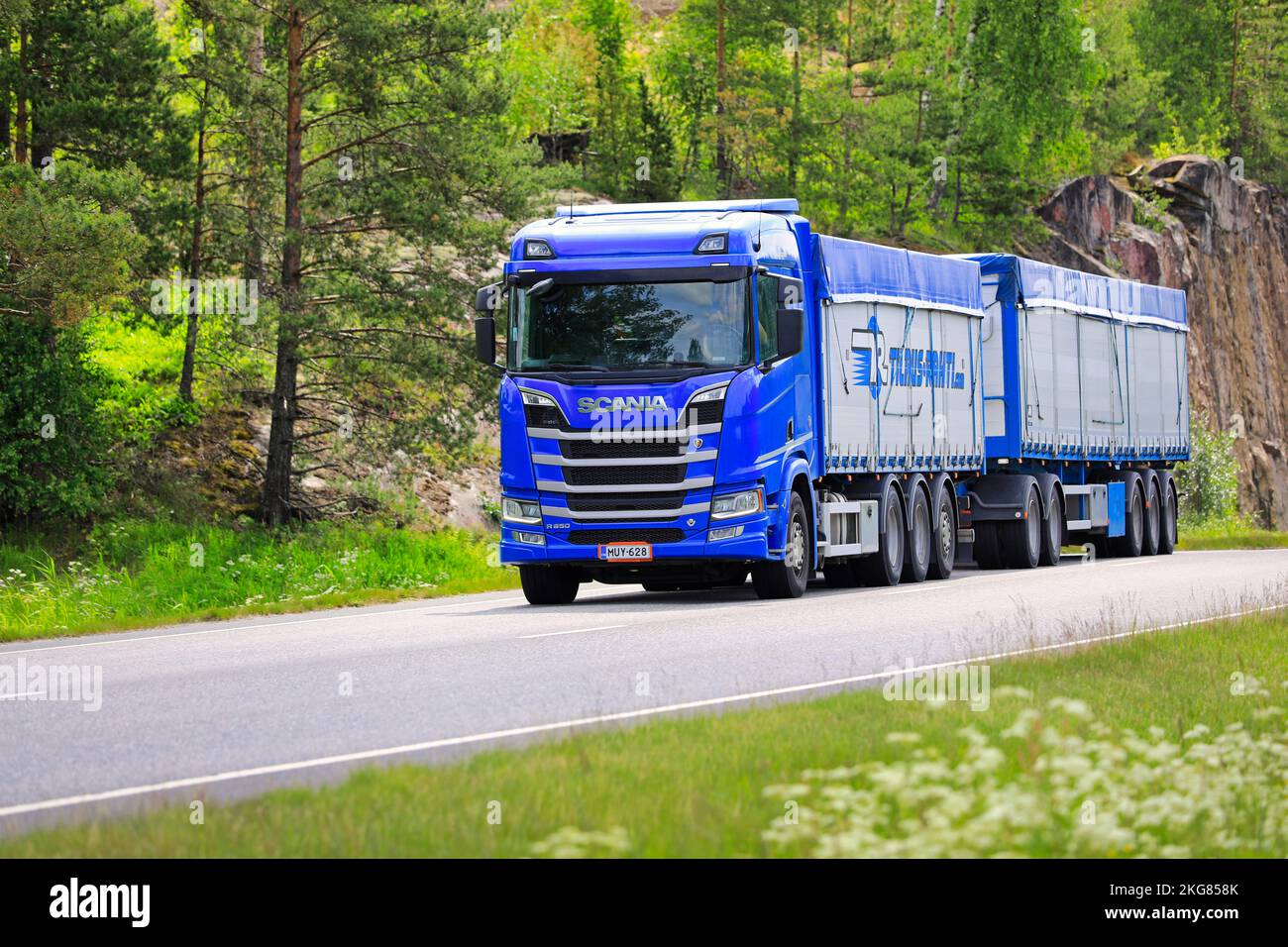Le camion Blue Scania R650 tire la remorque de marchandises en vrac pour le transport du grain le long de la route en été. Salo, Finlande. 23 juin 2022. Banque D'Images