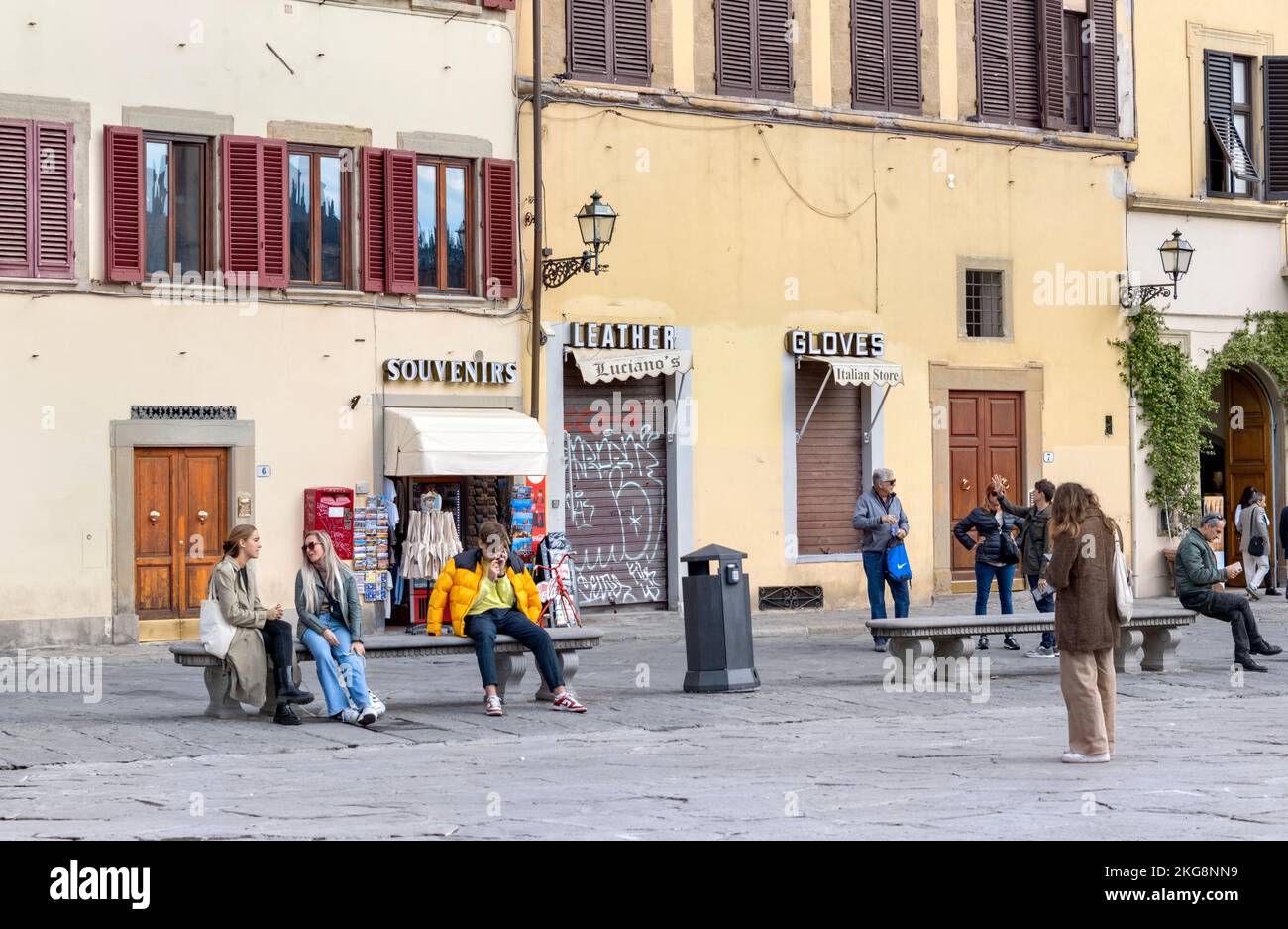 Personnes assises sur des bancs sur la place principale Piazza di Santa Croce, Florence, Italie novembre 2022 Banque D'Images