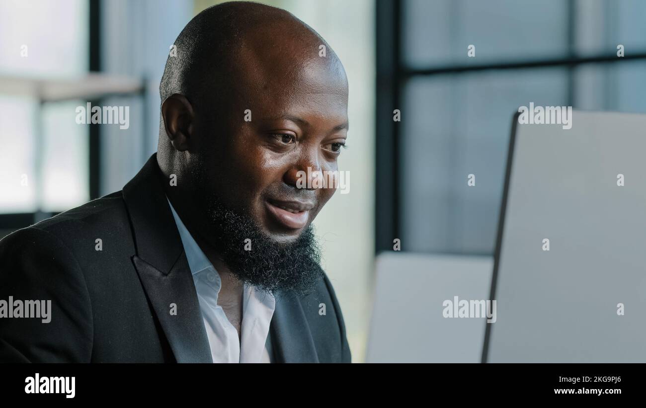 Focalisé entrepreneur africain tapant sur le clavier de travail à distance dans le bureau regarder le moniteur étudier en ligne cours de développement entreprise startup américaine Banque D'Images