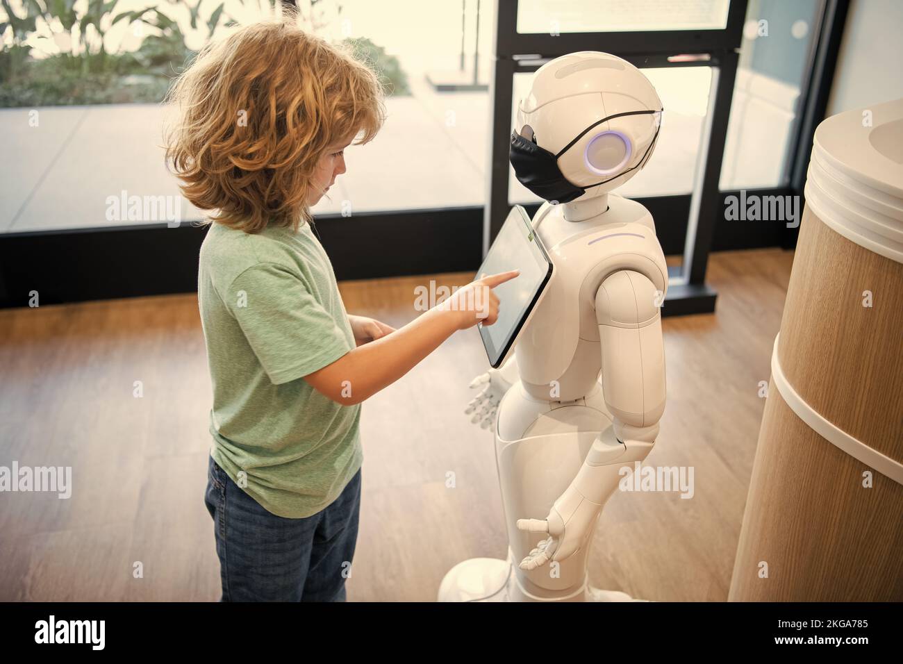 curieux enfant interagir avec robot intelligence artificielle, communication Banque D'Images