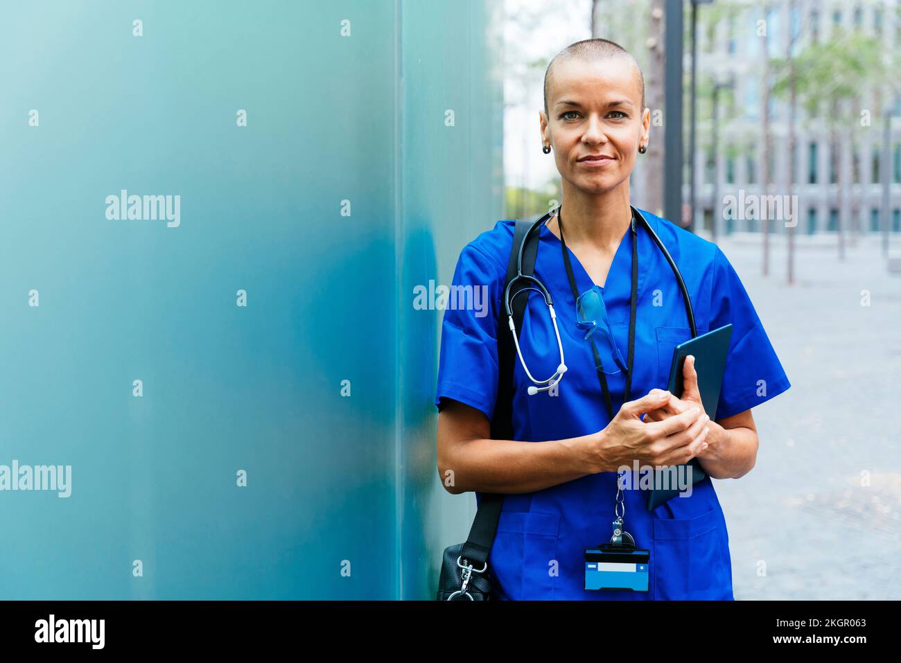 Infirmière féminine avec tête rasée tenant un PC tablette Banque D'Images