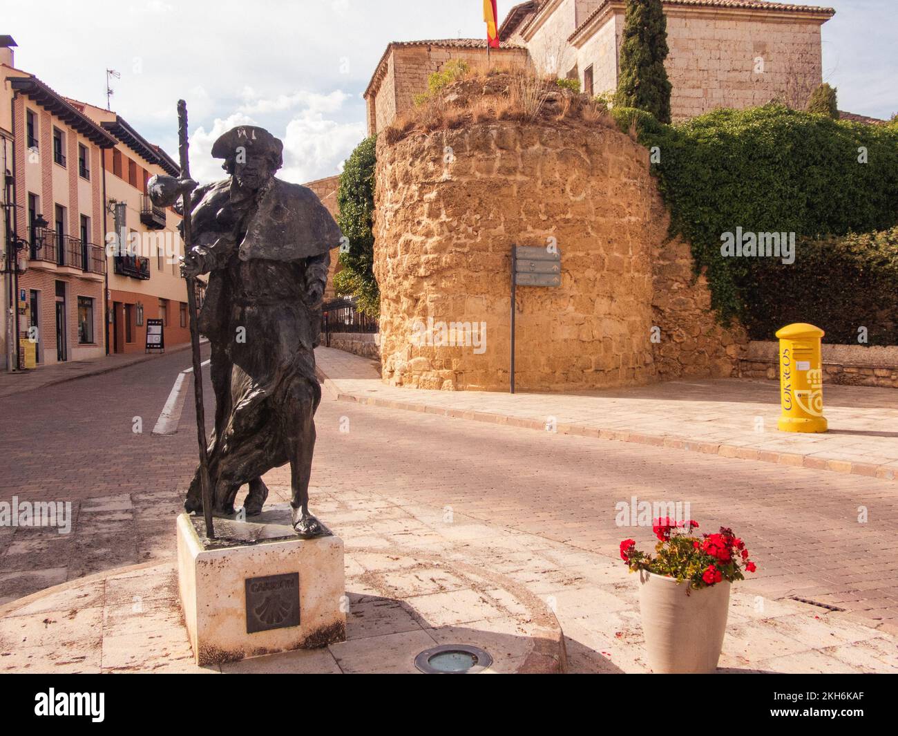 Statue LifeSize d'un pèlerin et vestiges de la muraille médiévale de la ville à l'entrée du centre historique Carrión de los Condes une étape importante sur le chemin de Saint James de la frontière française à Saint-Jacques-de-Compostelle. Banque D'Images