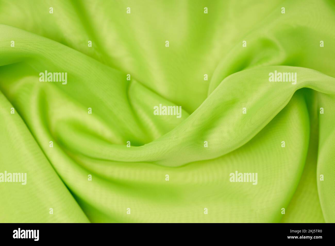magnifique soie verte. toile de fond ondulée. Photo de haute qualité Banque D'Images