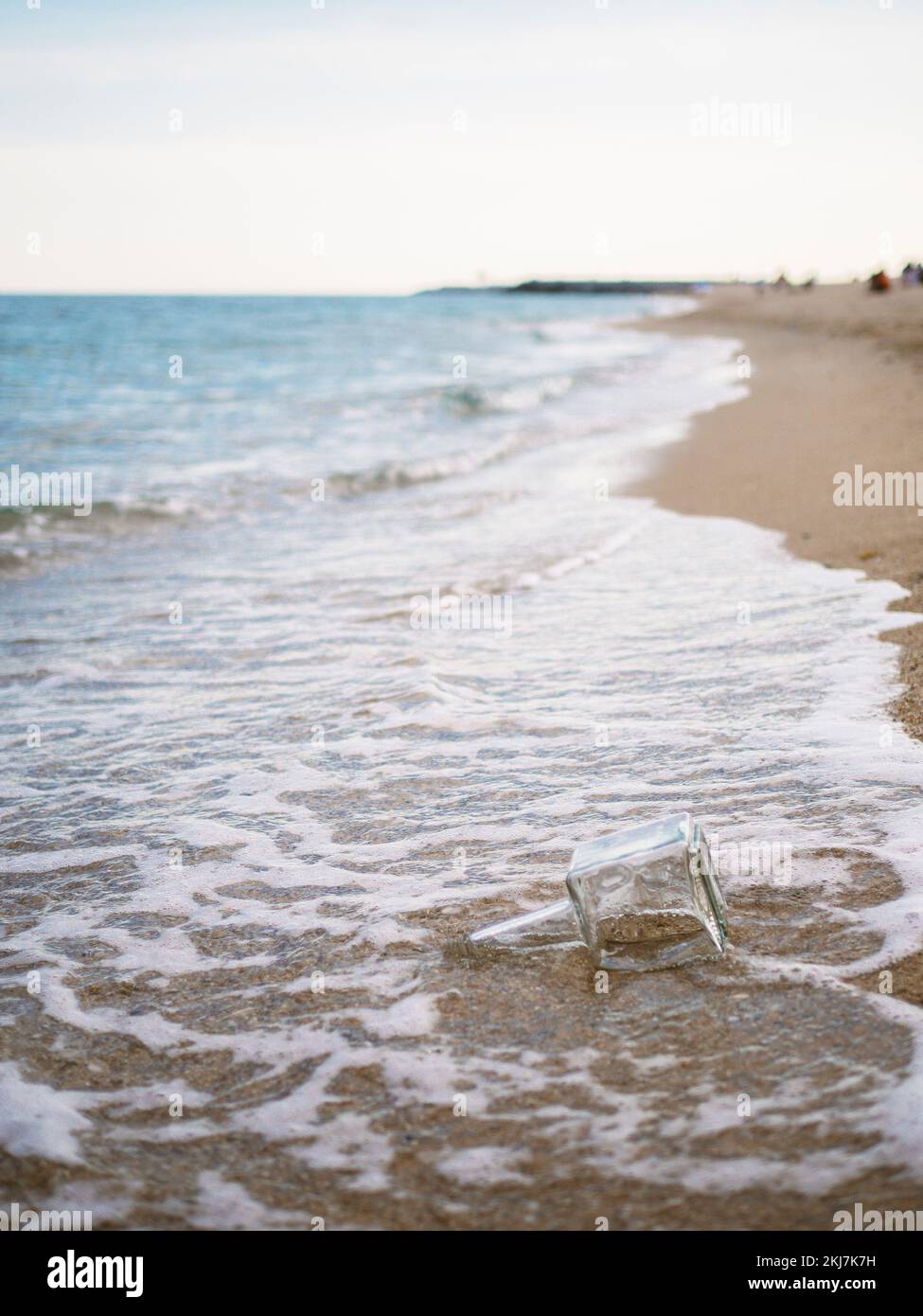 bouteille dans le sable sur la plage en été à la recherche de quelqu'un pour le trouver. Banque D'Images