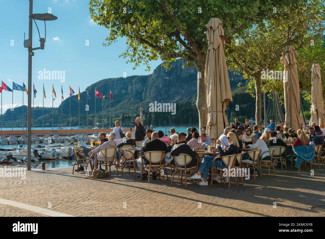 Lac de Garde, vue en été des personnes assis à l'extérieur des cafés et des bars de la Piazza Catullo dans la vieille ville de Garda, en Italie Banque D'Images