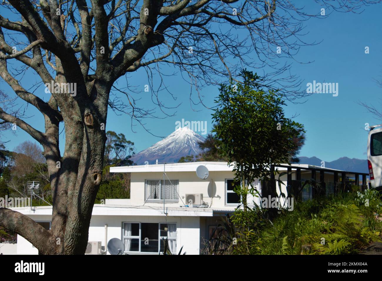Mt Taranaki Peeping Tom. La montagne est naine par les arbres environnants et la maison dans la photo, mais sa puissance vient par le milieu Banque D'Images