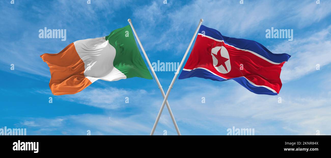 Deux drapeaux croisés la Corée du Nord et l'Irlande agitant sous le vent à ciel nuageux. Concept de relation, de dialogue, de voyage entre deux pays. 3d illustrateur Banque D'Images