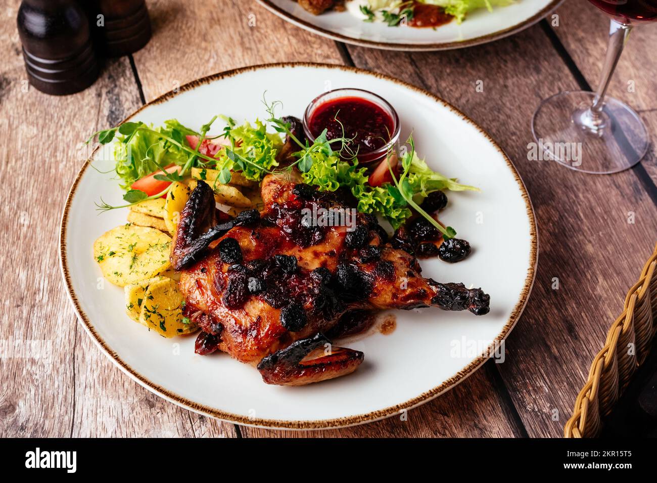 caille grillée avec sauce servie sur une assiette de légumes et h Banque D'Images