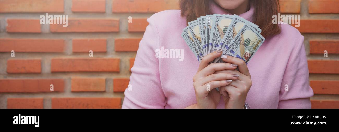 Gros plan d'une femme qui détient des billets en dollars. Banque D'Images