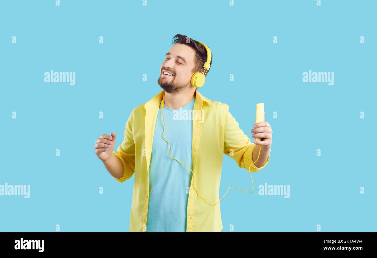 Un homme heureux écoute de la musique dans des écouteurs Banque D'Images