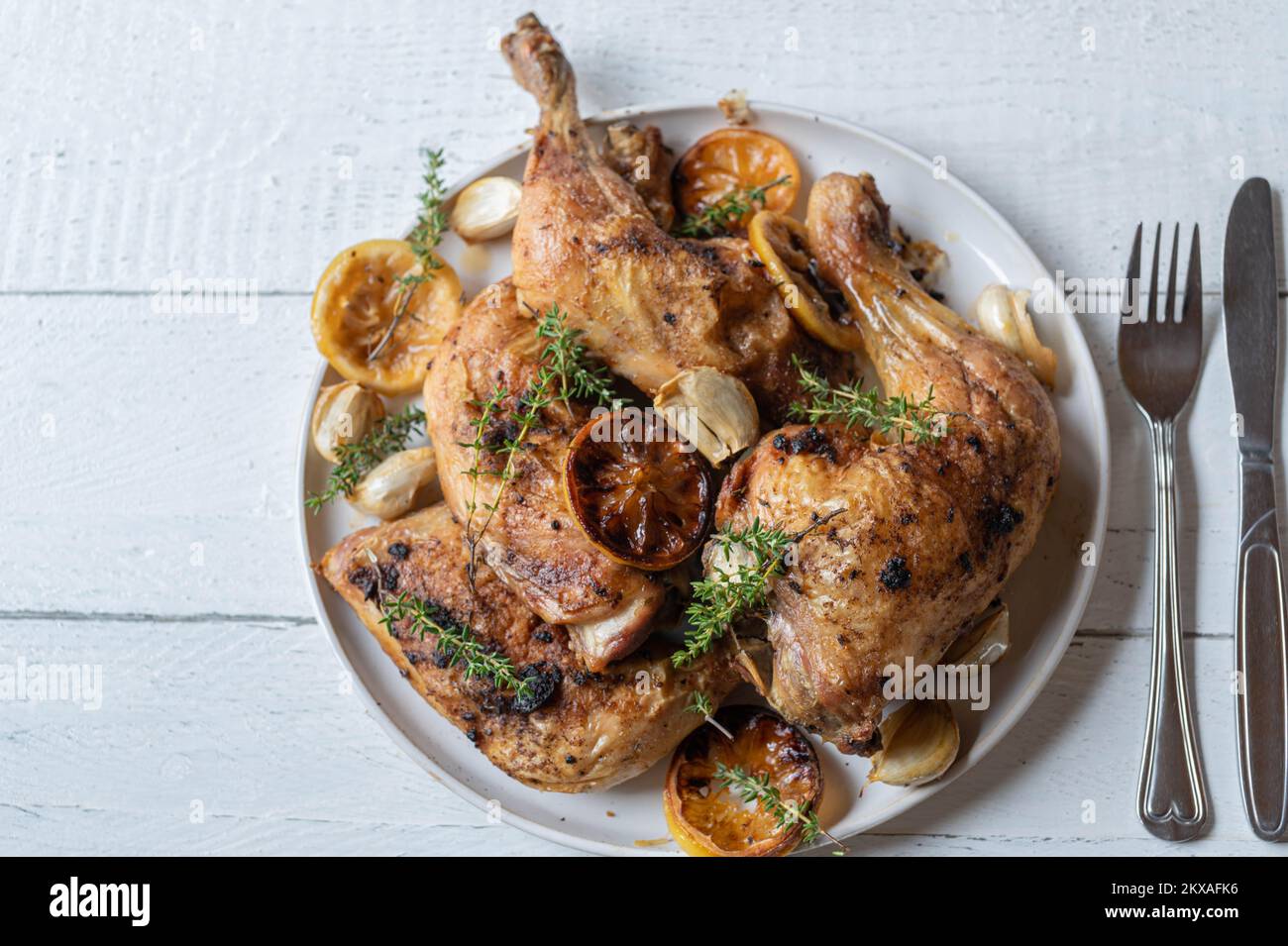 Poulet au citron avec thym et ail sur une assiette Banque D'Images