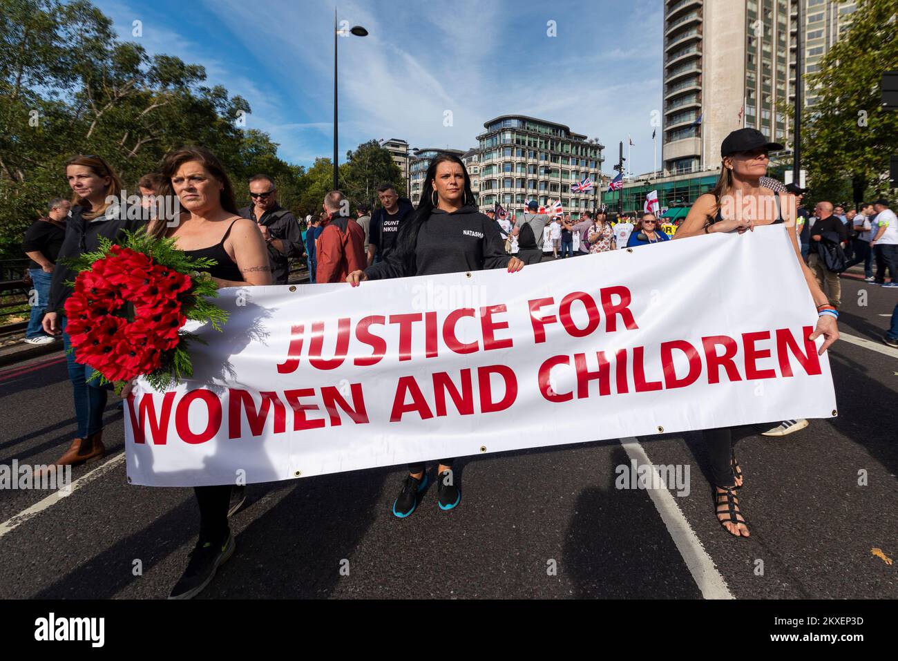 Femmes avec la bannière Justice pour les femmes et les enfants à une Alliance des lads de football démocratique, DFLA, a défilé vers le Parlement, Londres, Royaume-Uni, en signe de protestation Banque D'Images