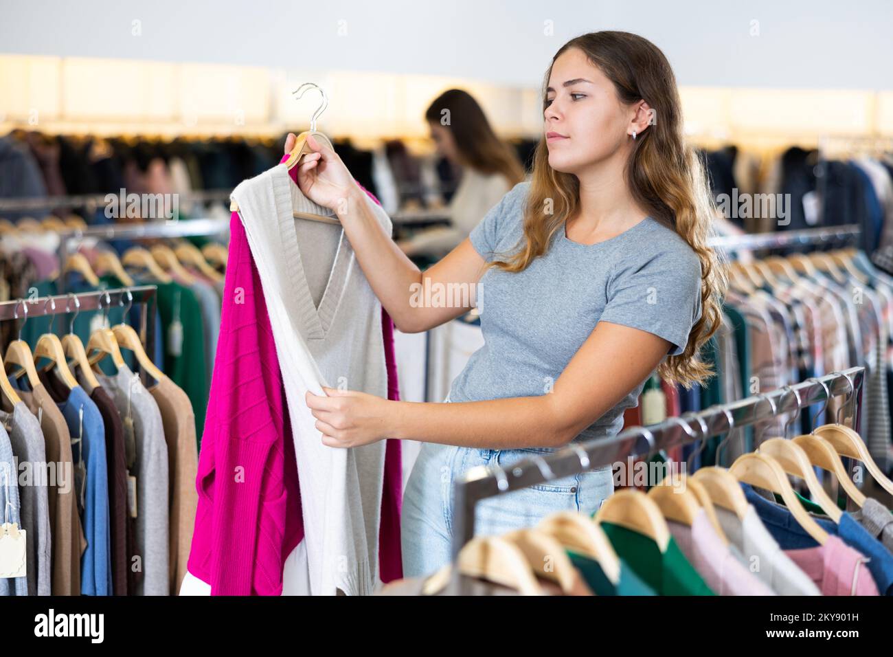Client qui décide d'un gilet en jersey dans une boutique de vêtements pour  femmes Photo Stock - Alamy