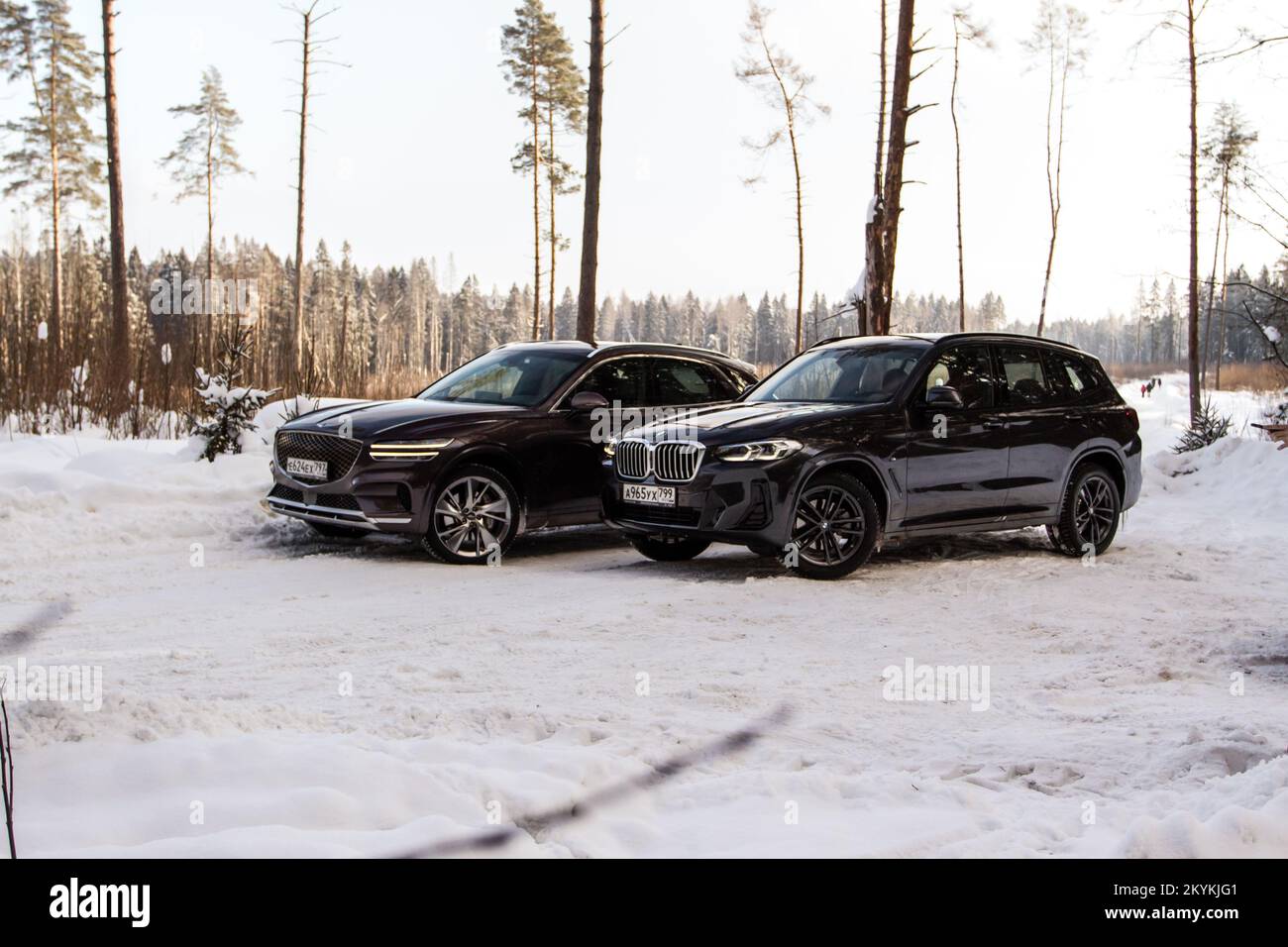 MOSCOU, RUSSIE - 05 FÉVRIER 2022 BMW X3 (G01) et Genesis GV70 (JK1), un modèle compact de voiture multisegment sur fond de nature. Côté extérieur avant cl Banque D'Images