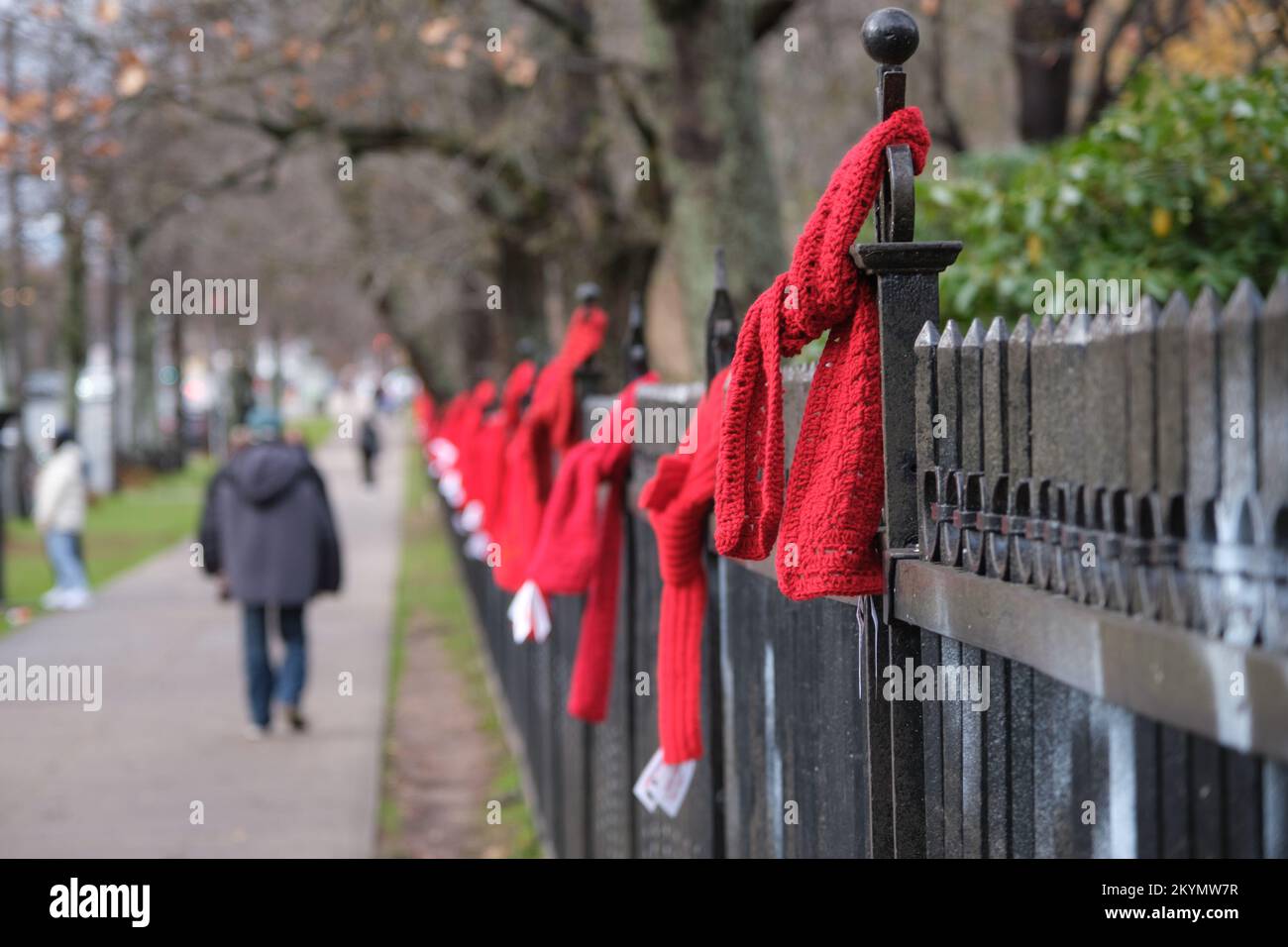 Halifax, Nouvelle-Écosse, Canada. 1 décembre 2022. Les bénévoles nouent des foulards  rouges pour sensibiliser la population à la Journée mondiale du sida le  long de la clôture des jardins publics. Près de