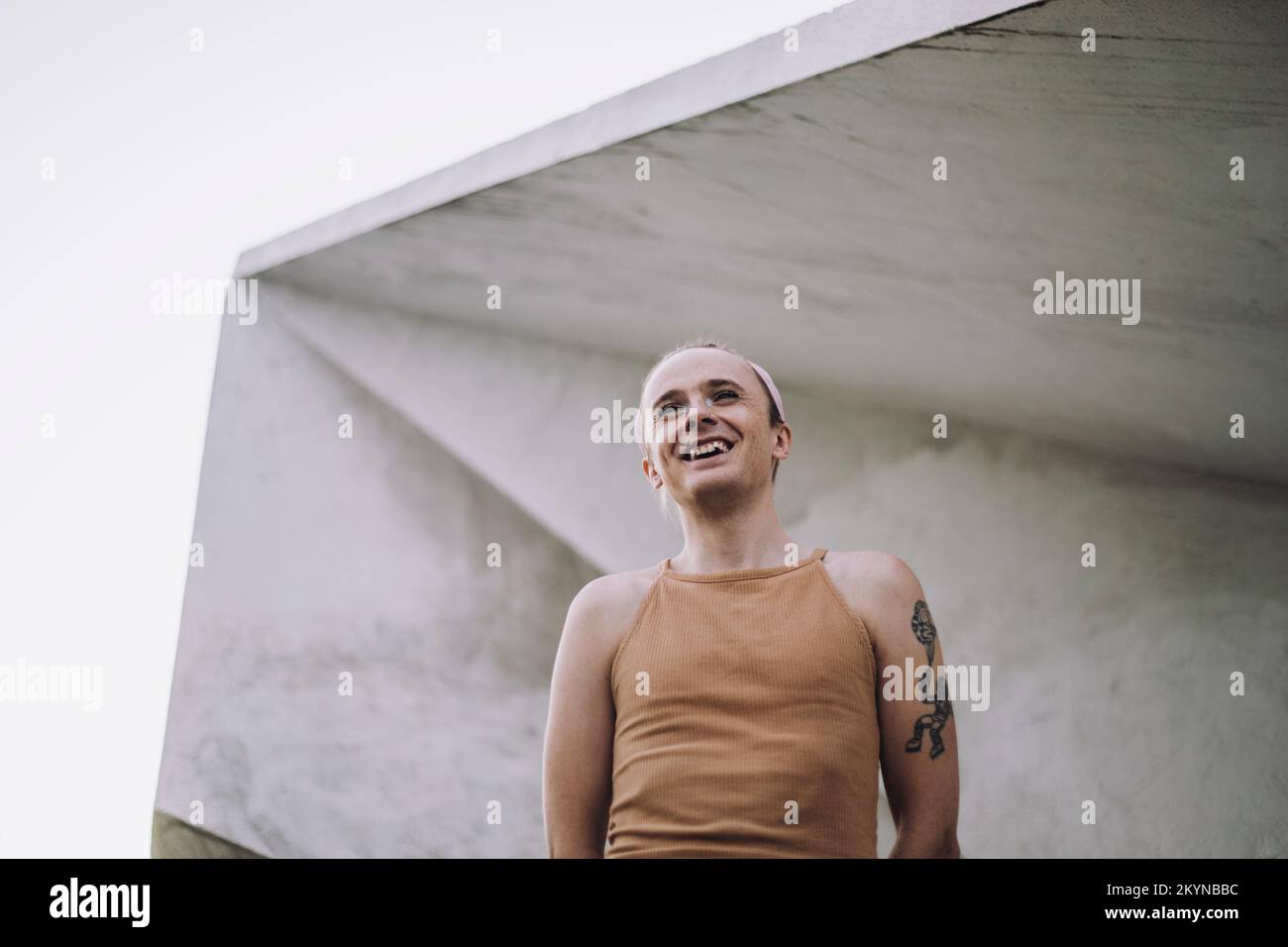 Vue à angle bas de la personne non binaire debout contre le mur Banque D'Images