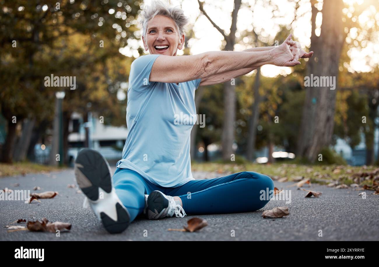 Fitness, parc et stretching femme senior sur le terrain dans l'entraînement, l'entraînement et l'énergie pour le bien-être du corps, la guérison en plein air et la santé mentale. Personnes âgées Banque D'Images