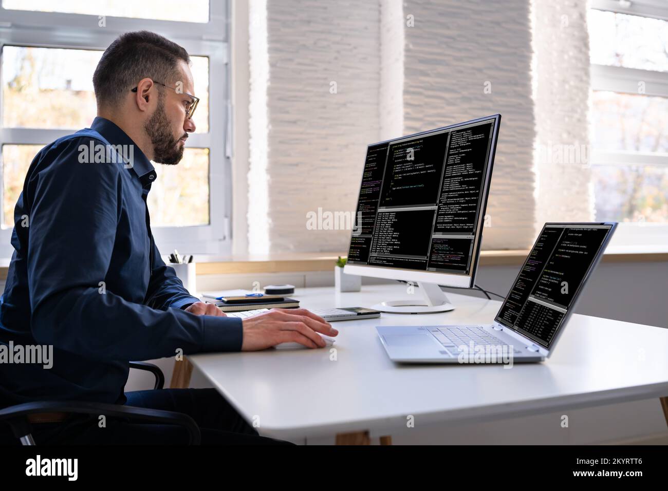 Programmeur de logiciel ou Coder Man utilisant un ordinateur de bureau Banque D'Images