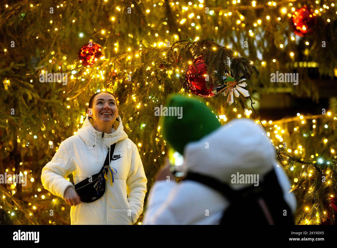 Une femme réagit alors qu'elle pose une photo sur le marché de Noël à Riga, en Lettonie, 2 décembre 2022. REUTERS/Ints Kalnins Banque D'Images