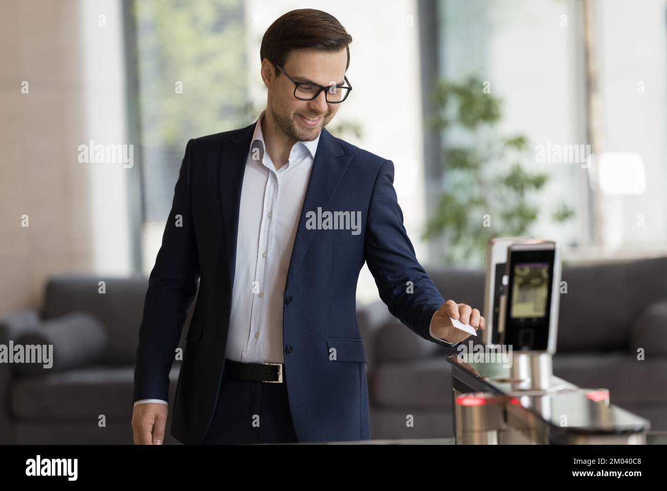 Homme d'affaires glisser carte de passe au lecteur électronique, ouvre les portes automatiques Banque D'Images