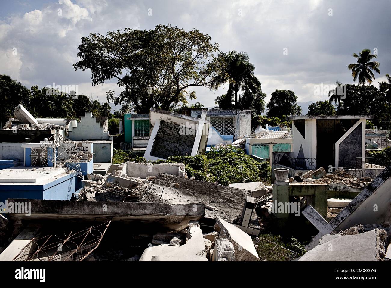 La ville de Leogane est située très près de l'épicentre du tremblement de terre à Haïti et 80 pour cent de la ville se trouve en ruines. Des milliers de réfugiés tentent de s'échapper des destructions. Dans la rue principale de Leogane, la plupart des bâtiments sont en ruines. L'apathie est omniprésente et seules des tentatives sporadiques sont faites pour creuser dans les ruines. Banque D'Images