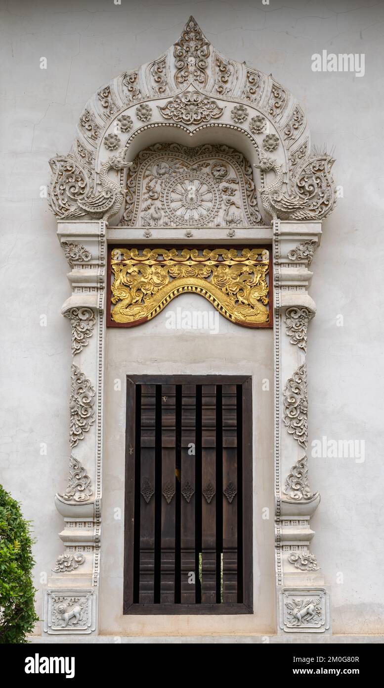 Fenêtre avec stuc et cadre de sculpture en bois doré du principal vihara ou viharn au célèbre temple bouddhiste historique Wat Chedi Luang, Chiang Mai, Thaïlande Banque D'Images