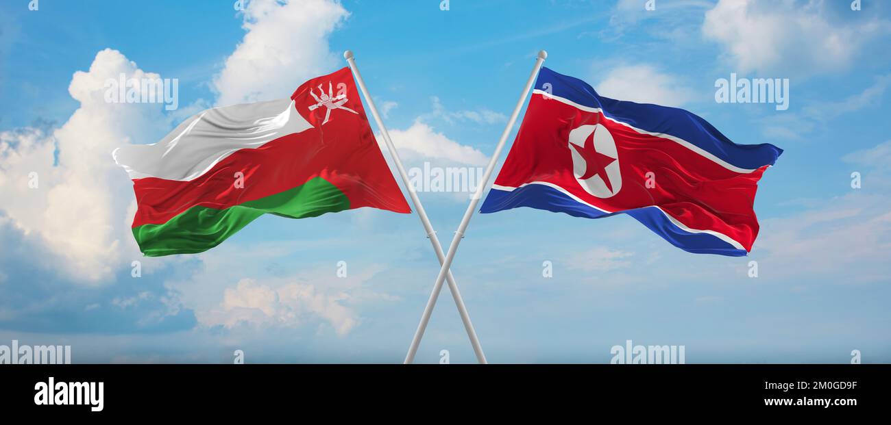 Deux drapeaux croisés la Corée du Nord et Oman agitant dans le vent à ciel nuageux. Concept de relation, de dialogue, de voyage entre deux pays. 3d illustrationratio Banque D'Images