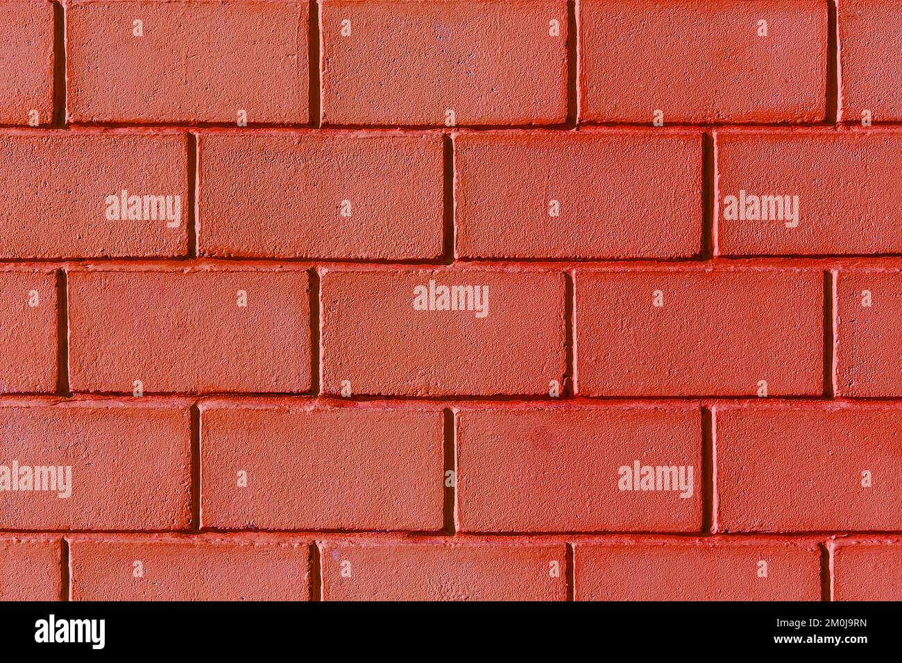 Peinture rouge mur briques blocs extérieur façade texture arrière-plan maison abstraite maison. Banque D'Images