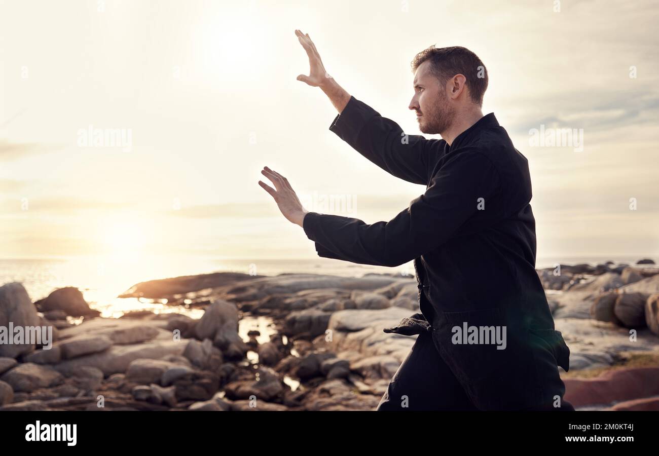 Nature, zen et tai chi, homme sur la plage pour l'équilibre et la paix pour le bien-être mental ou le contrôle du corps et de l'esprit. La santé spirituelle, la forme physique et la méditation Banque D'Images