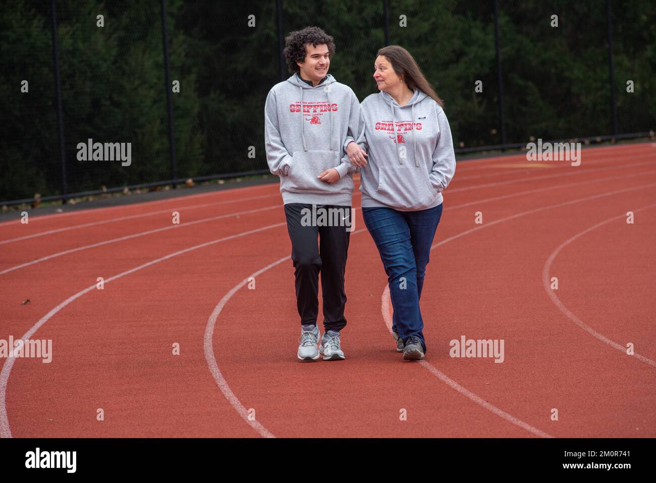 Sebastian DeSimone, un étudiant de l'Université Gwynedd Mercy ayant des déficiences intellectuelles, marche avec sa mère Joanne de Simone sur la piste universitaire Banque D'Images