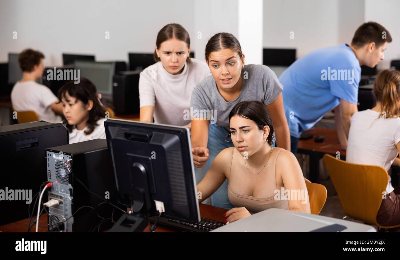 Enseignant et adolescentes étudiant en informatique Banque D'Images