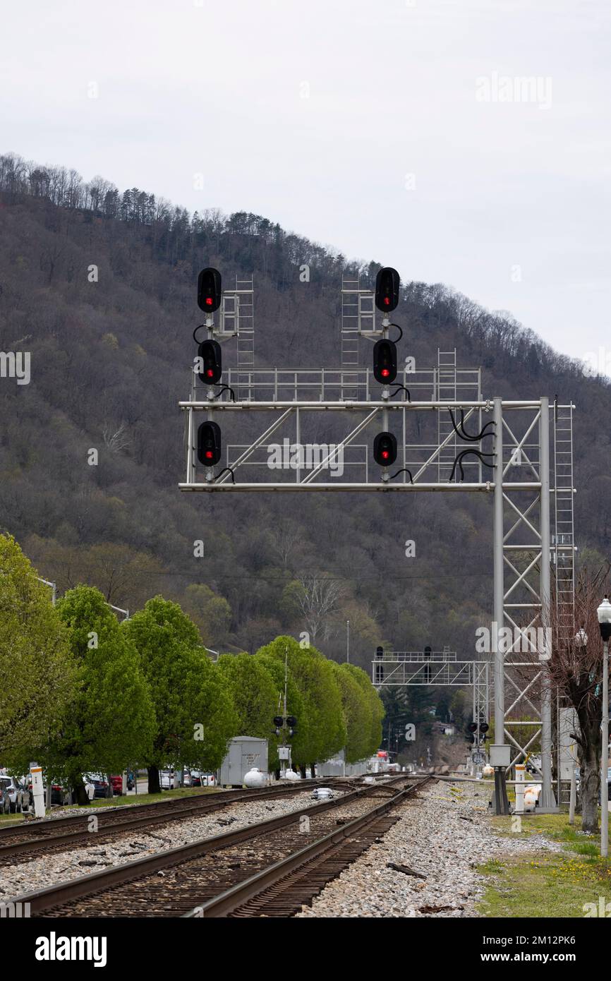 Une grande structure de pont de signalisation ferroviaire en métal de style cantilever surplombe deux voies principales dans une petite ville des Appalaches en Virginie occidentale. Banque D'Images