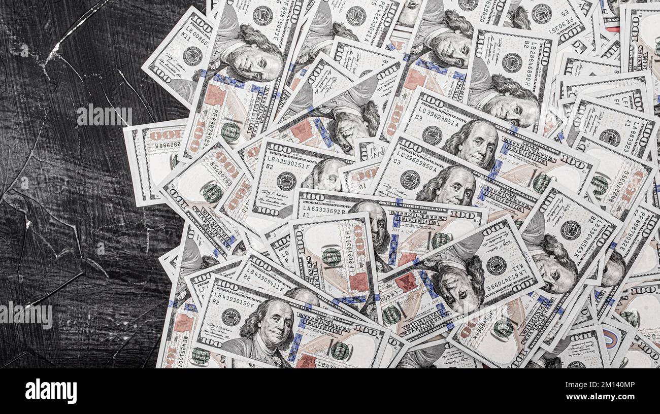 Dollars américains sur fond de ciment noir. Des factures de cent dollars. Banque D'Images