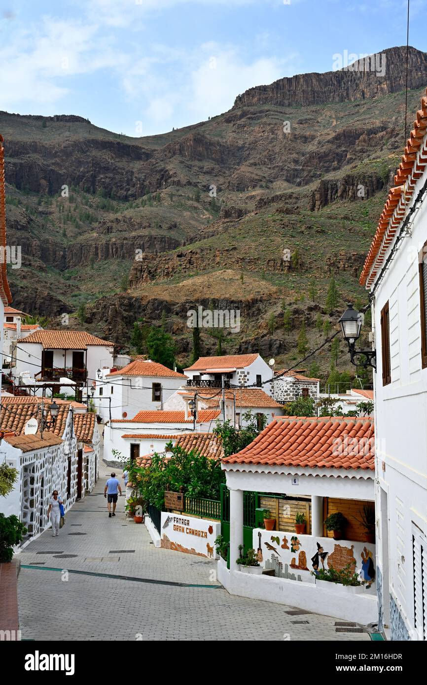 Petite rue étroite dans le village de montagne de Fataga avec des toits de tuiles rouges et des montagnes accidentées derrière, Gran Canaria Banque D'Images