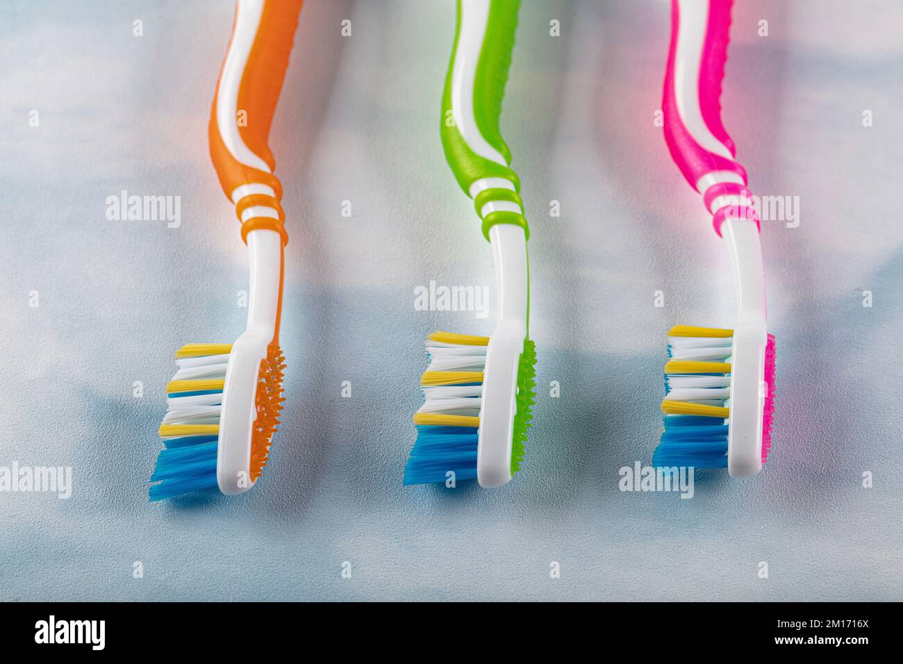Brosses à dents en plastique avec poignées colorées sur fond de couleur. Banque D'Images