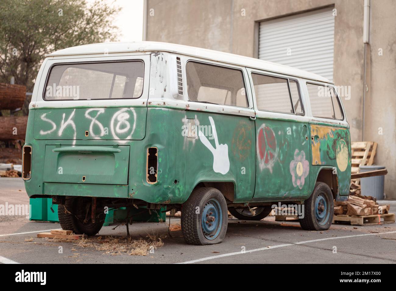 Un vieux bus Volkswagen abandonné peint par pulvérisation dans un parking Banque D'Images