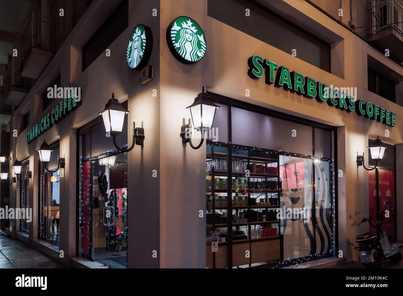 Salonique, Grèce café Starbucks avec logo Medusa et décoration de saison. Vue extérieure en soirée sur la célèbre chaîne de cafés avec illustration des boissons de Noël. Banque D'Images