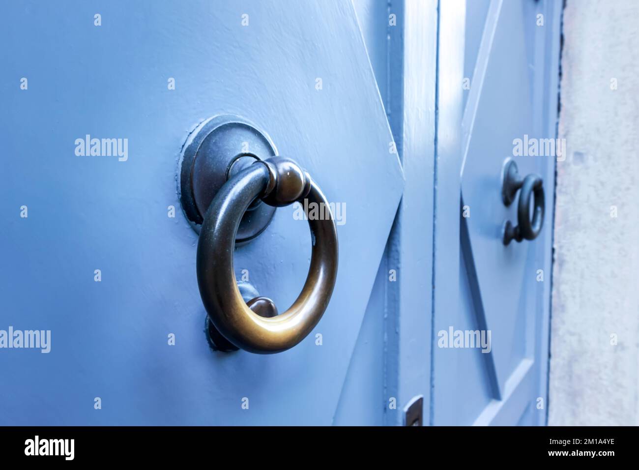 Porte texturée bleue avec poignée circulaire en métal doré Banque D'Images