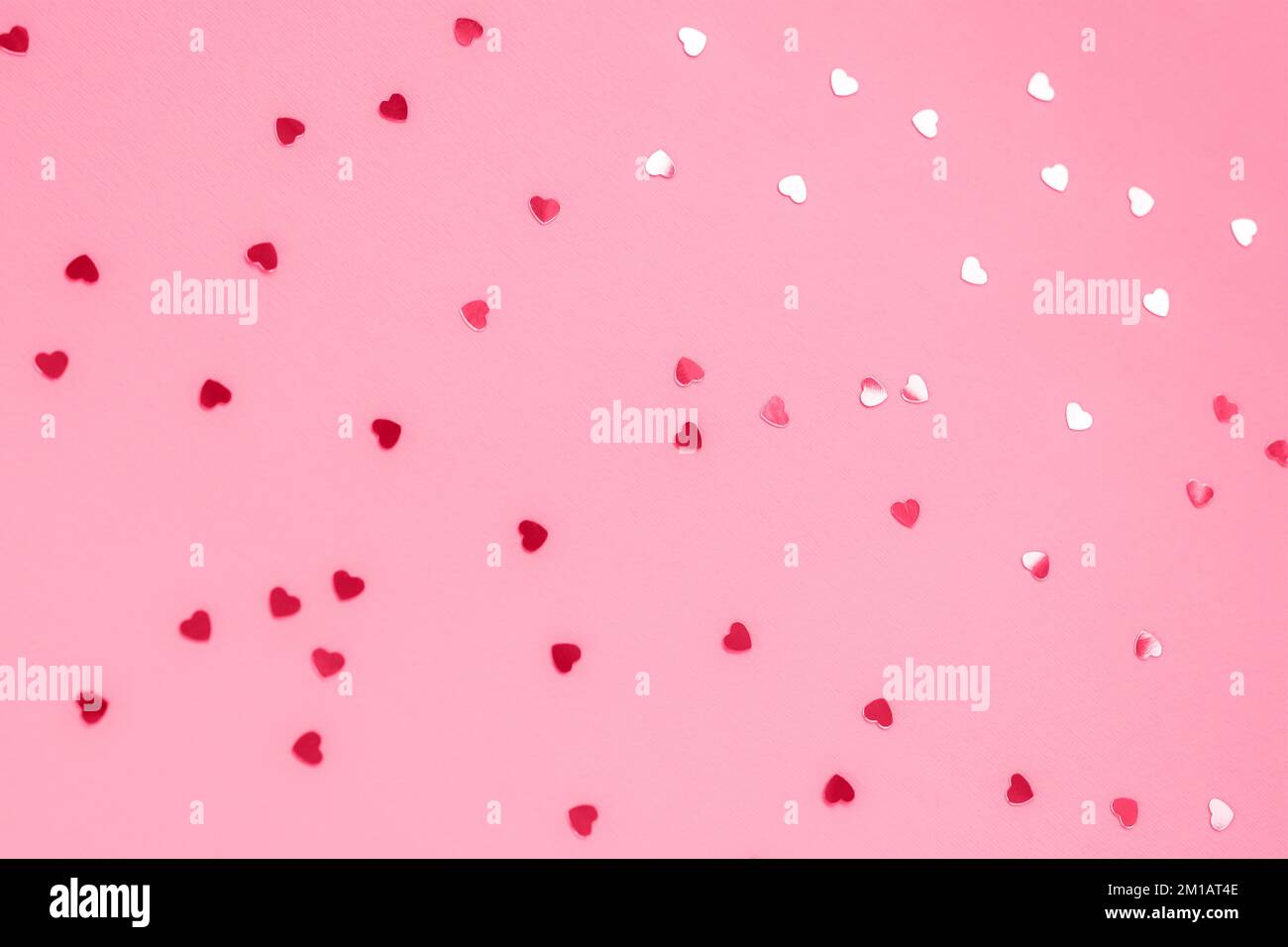 Fond de fête rose avec confetti, texture.Mise au point sélective. Banque D'Images