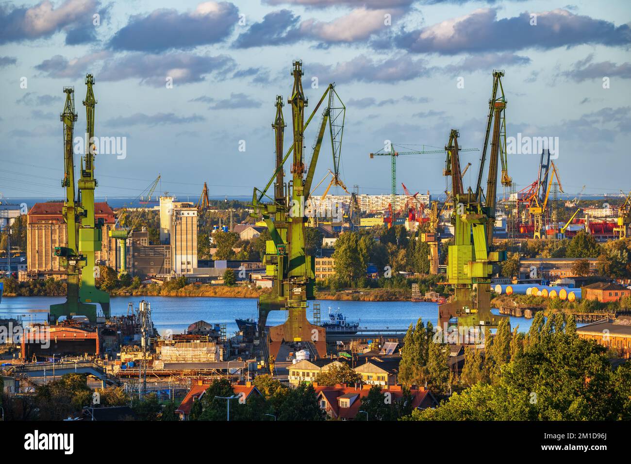 Ville de Gdansk ville industrielle en Pologne, chantier naval de Gdansk avec ses célèbres grues historiques au coucher du soleil. Banque D'Images