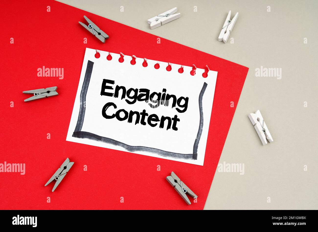 Concept commercial et financier. Épingles à linge et une feuille de carnet avec l'inscription - contenu engageant Banque D'Images