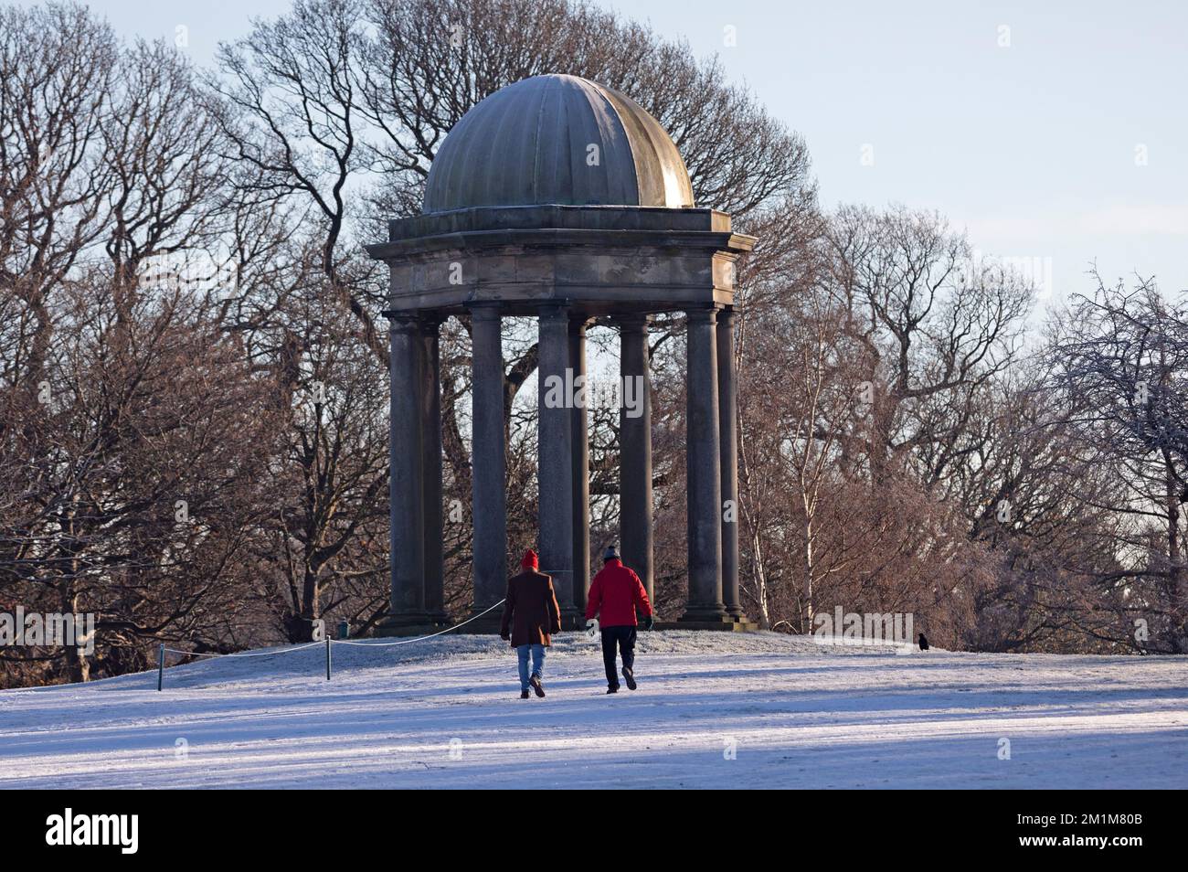 Édimbourg, Écosse, Royaume-Uni. 13th décembre 2022. Les résidents se sont réveillés jusqu'à geler moins 7 degrés centigrades dans la capitale écossaise, le gel intense hier et aujourd'hui faisant pour des conditions très verglacées. Deux mâles plus âgés font une promenade à travers le parcours de golf de Duddingston, autrement déserté, avec le monument en arrière-plan. Credit: ArchWhite/alamy Live news Banque D'Images
