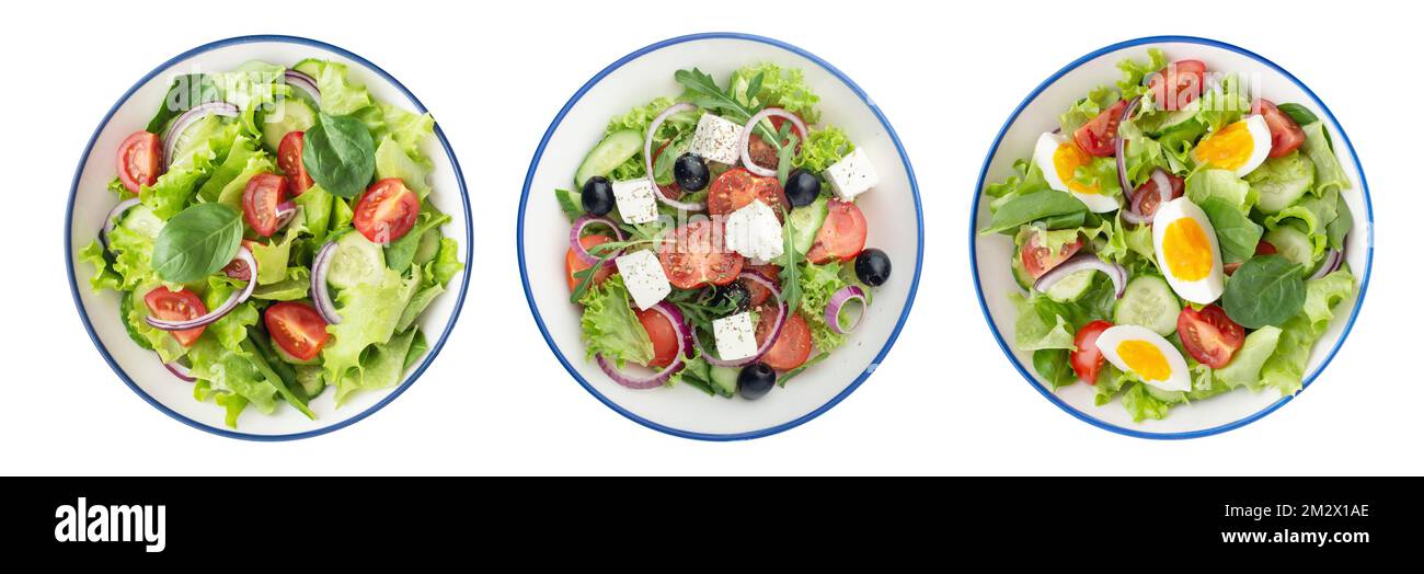Assiettes avec différentes salades sur fond blanc Banque D'Images