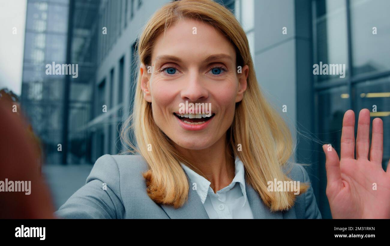 Vue rapprochée de la webcam jeune femme blogger positif enregistre vlog en orrant bonjour parler sur appel vidéo en utilisant le smartphone en plein air réussi Banque D'Images