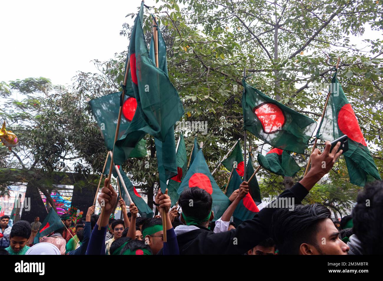 Narayanganj, Dhaka, Bangladesh. 16th décembre 2022. Le peuple tient le drapeau national du Bangladesh pour célébrer le jour de la victoire de 52nd, qui marque la fin d'une guerre amère de neuf mois d'indépendance par rapport au Pakistan, à Narayanganj, au Bangladesh. Le Bangladesh célèbre le 52nd anniversaire de sa victoire nationale, en rappelant les vaillants combattants de la liberté qui ont combattu et fait le sacrifice ultime pour libérer le pays des forces pakistanaises. Les gens de tous les milieux se réunissent au Narayanganj Central Shaheed Minar dans la matinée pour marquer le jour le plus précieux du peuple Bangali à l'occasion du Cr Banque D'Images