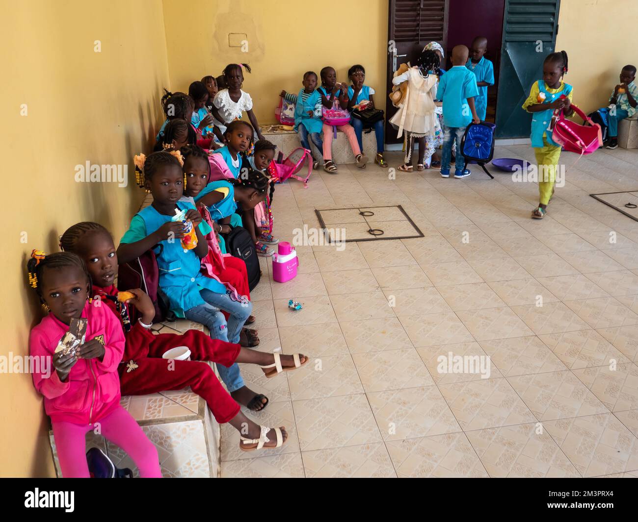 MBOUR, SÉNÉGAL - JANVIER CIRCA, 2021. Petits enfants noirs mignons non identifiés les enfants avec des uniformes sont assis sur un banc dans leur école primaire. Vin Banque D'Images