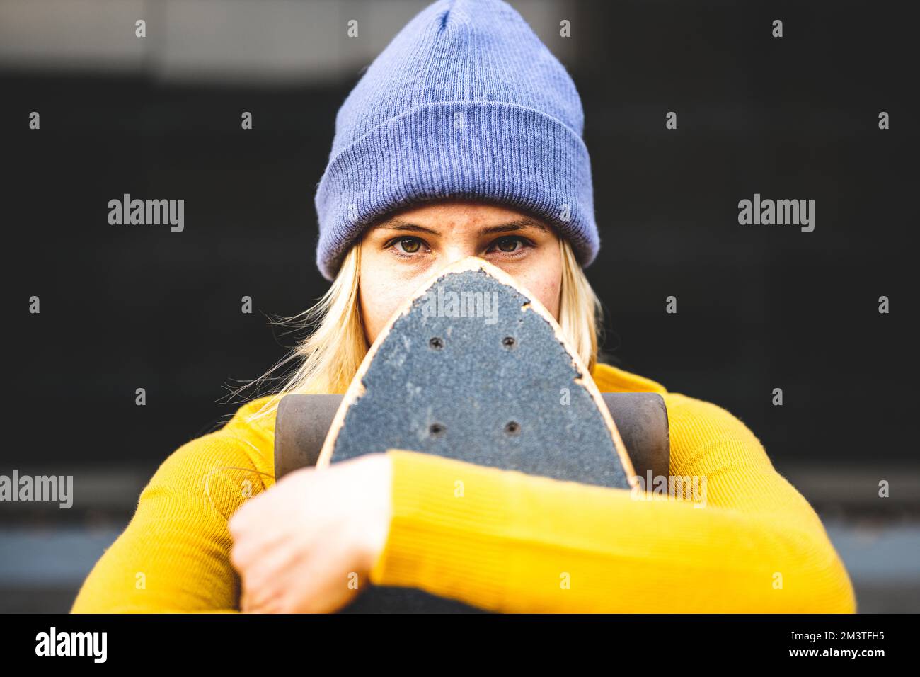 Regard intense sur le visage d'une jeune femme qui utilise le skateboard, la génération Z et le mode de vie des jeunes Banque D'Images