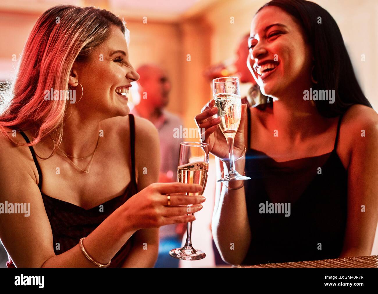 Sœurs pour la vie. deux jeunes femmes gaies bavardent tout en prenant un verre dans un bar le soir. Banque D'Images