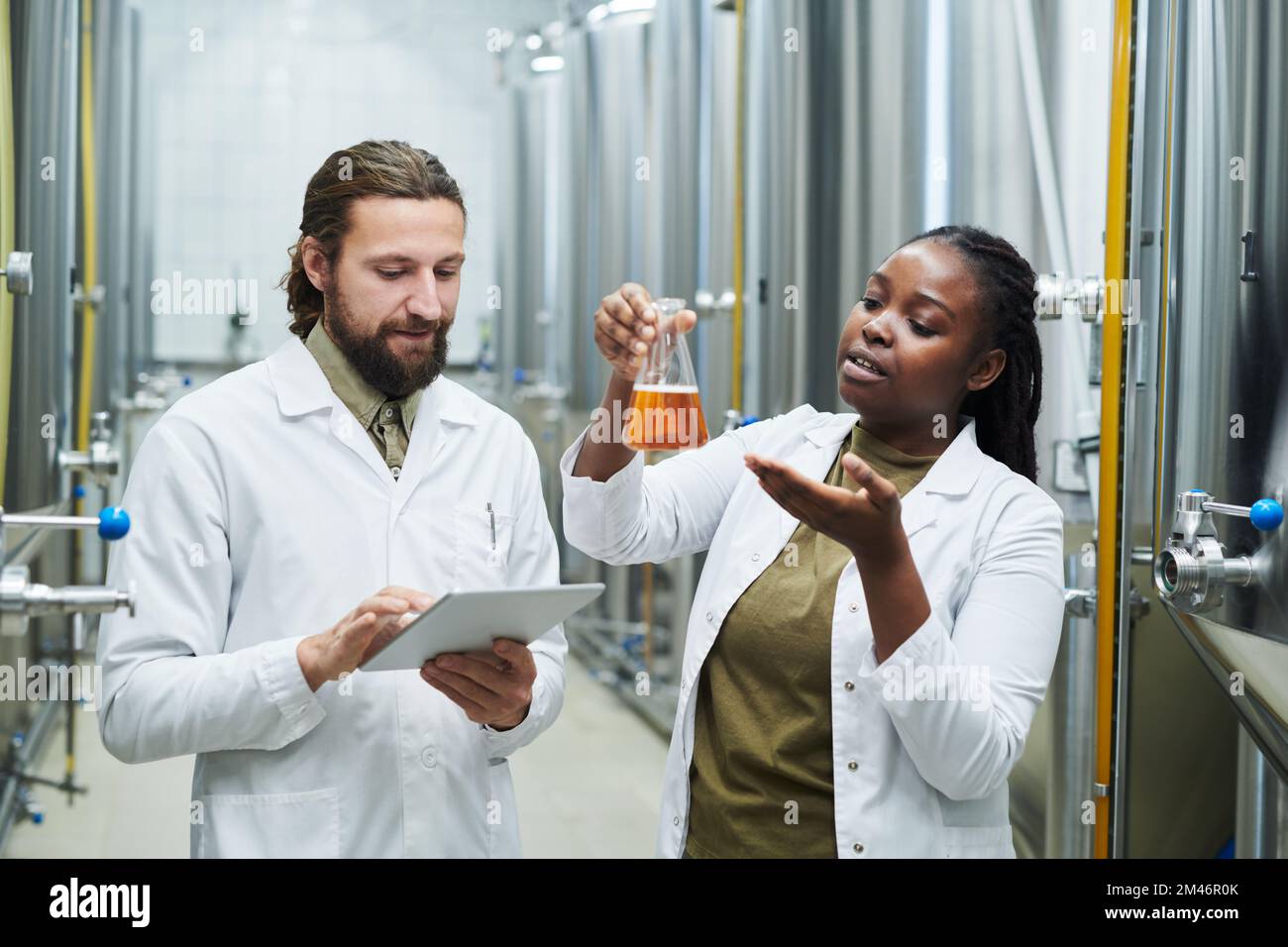 Les travailleurs de laboratoire qui vérifient la qualité de la bière produite à la brasserie Banque D'Images