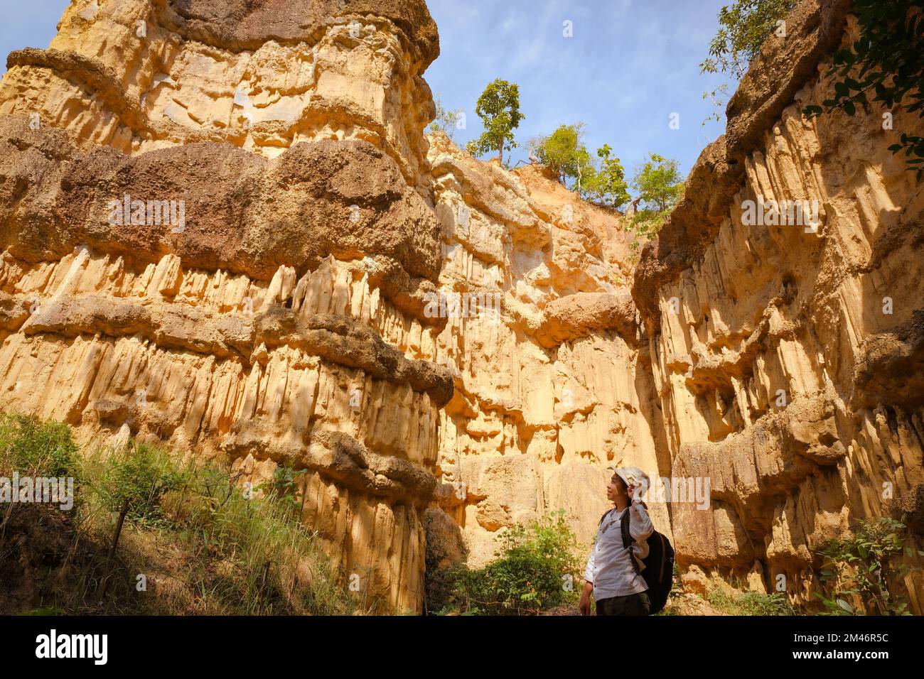 Femme géologue avec sac à dos explorant le sentier de la nature en forêt et analysant le rocher ou le gravier. Les chercheurs recueillent des échantillons de matériel biologique. Env Banque D'Images